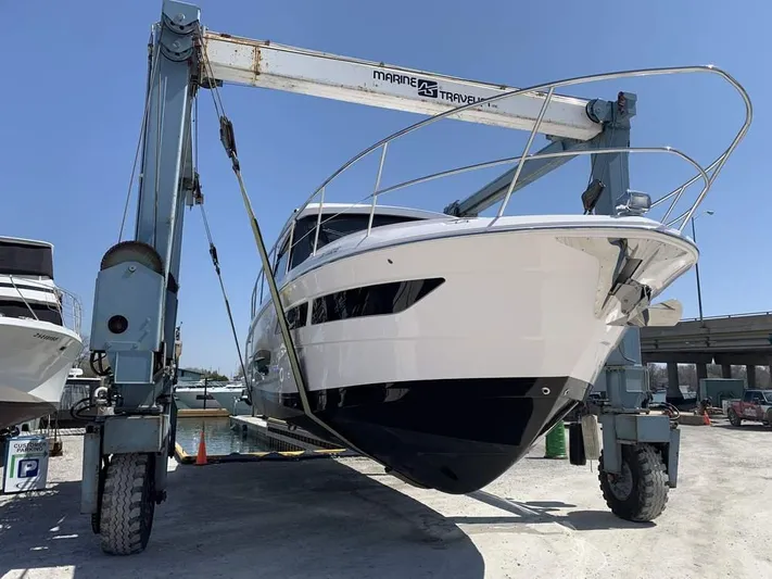 Yacht Photos Pics 2021 Regal 38 Grande Coupe yacht on a lift at a marina.
