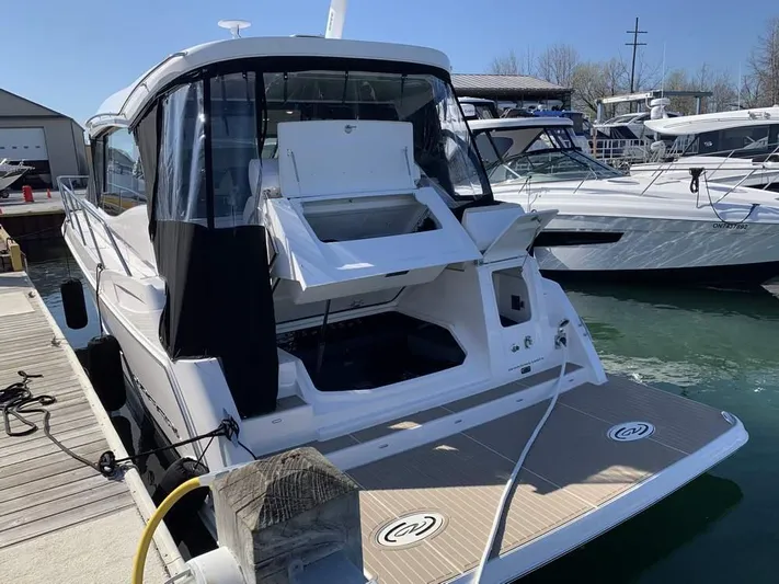  Yacht Photos Pics 2021 Regal 38 Grande Coupe docked at marina, rear view with open hatch.