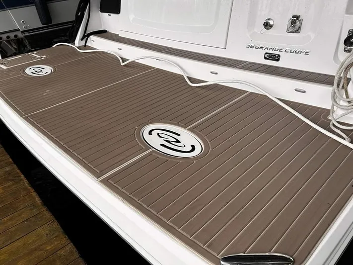  Yacht Photos Pics 2021 Regal 38 Grande Coupe swim platform with teak-style decking and logo.