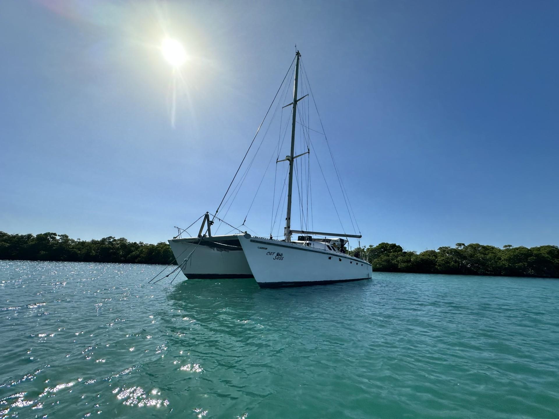 1972 Custom 53 Catamaran sailing on clear blue water under a bright sun.