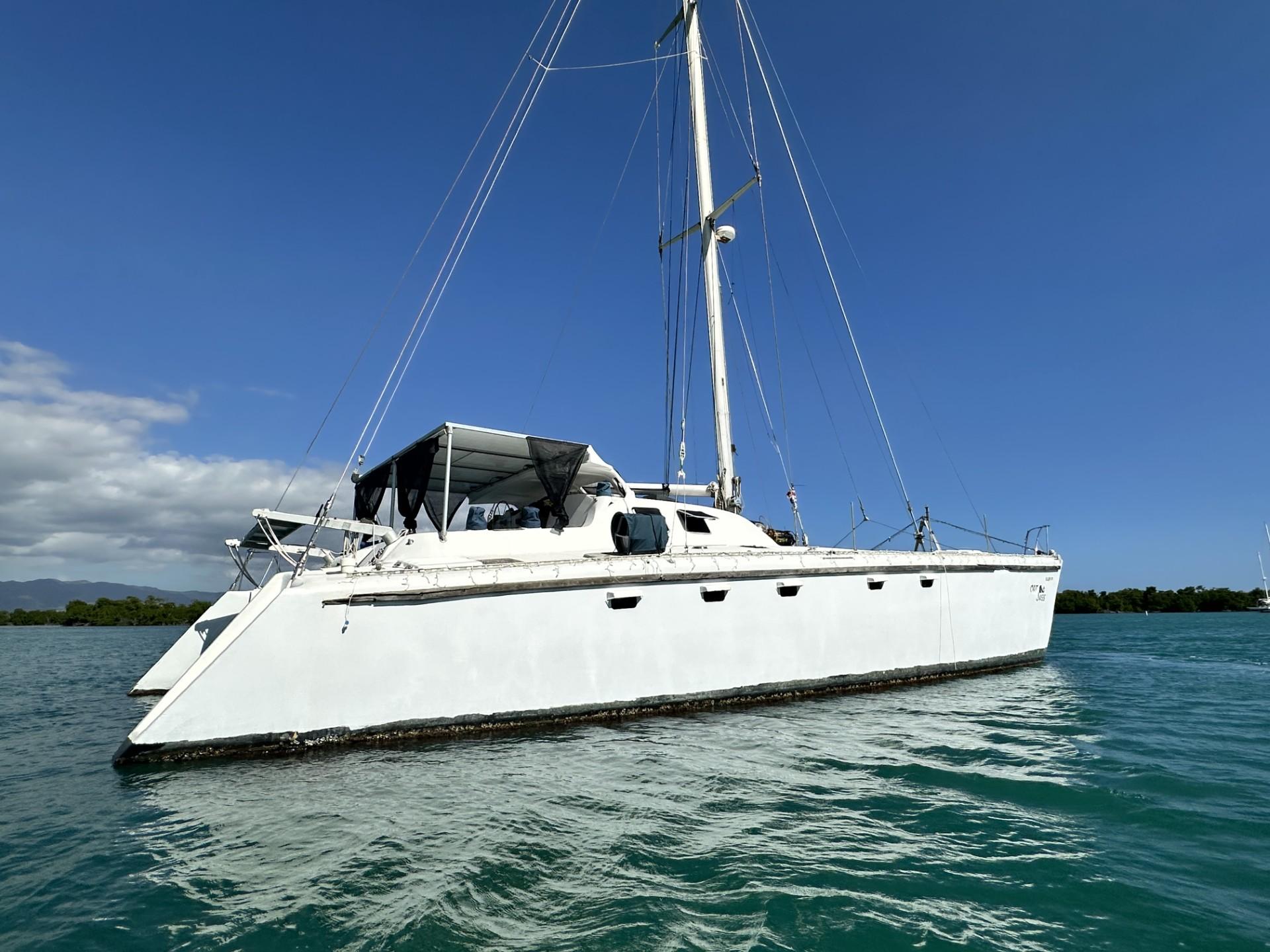 1972 Custom 53 Catamaran sailing on clear blue water under a sunny sky.