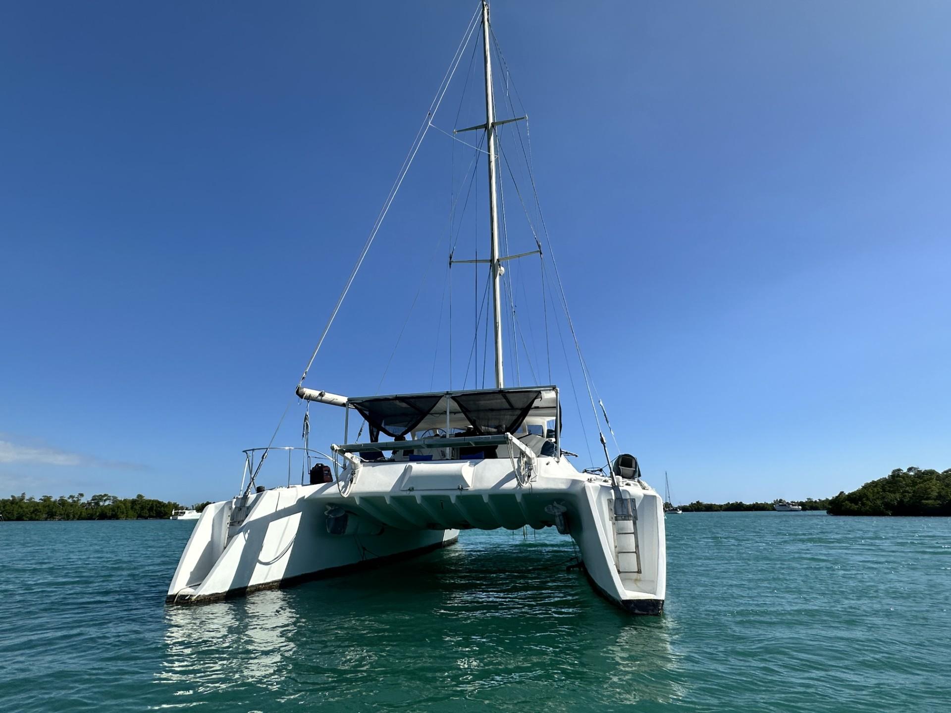 1972 Custom 53 Catamaran sailing on calm blue waters under clear sky.