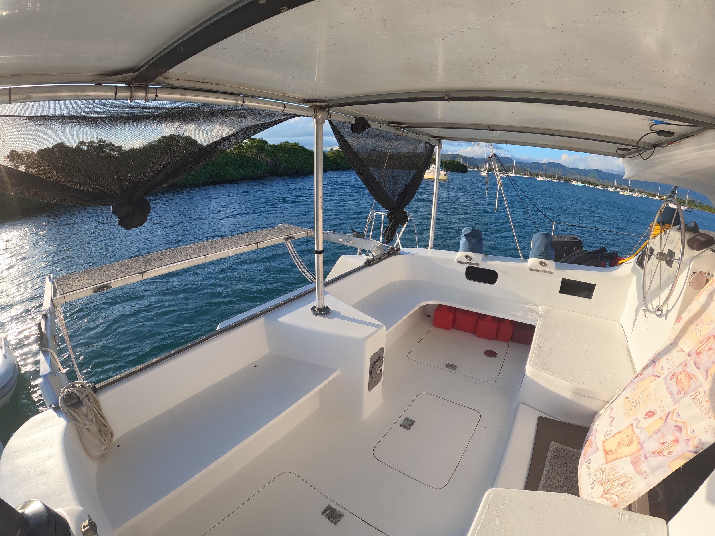 1972 Custom 53 Catamaran on serene water, featuring spacious deck and canopy.