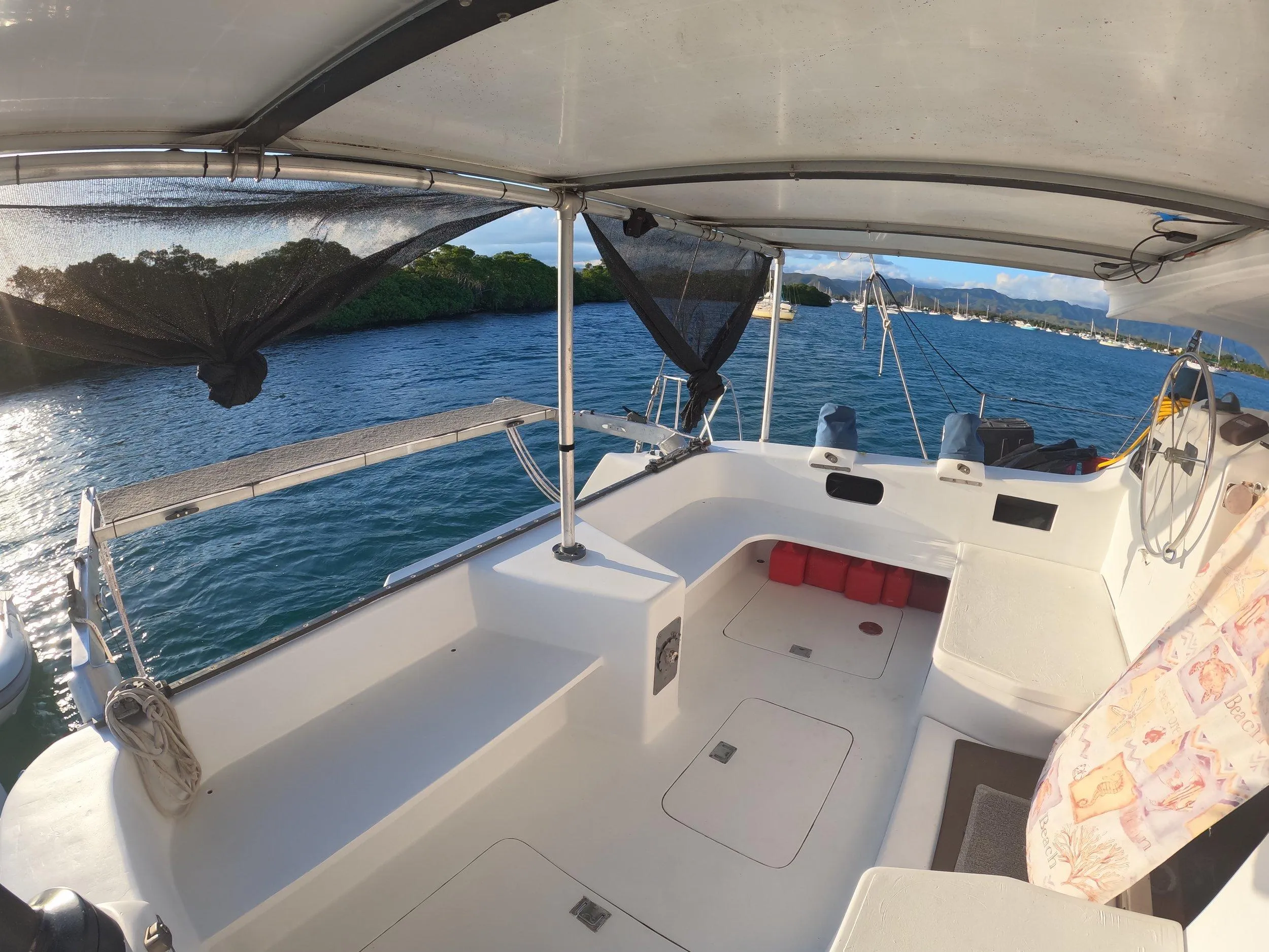 1972 Custom 53 Catamaran on serene water, featuring spacious deck and canopy.