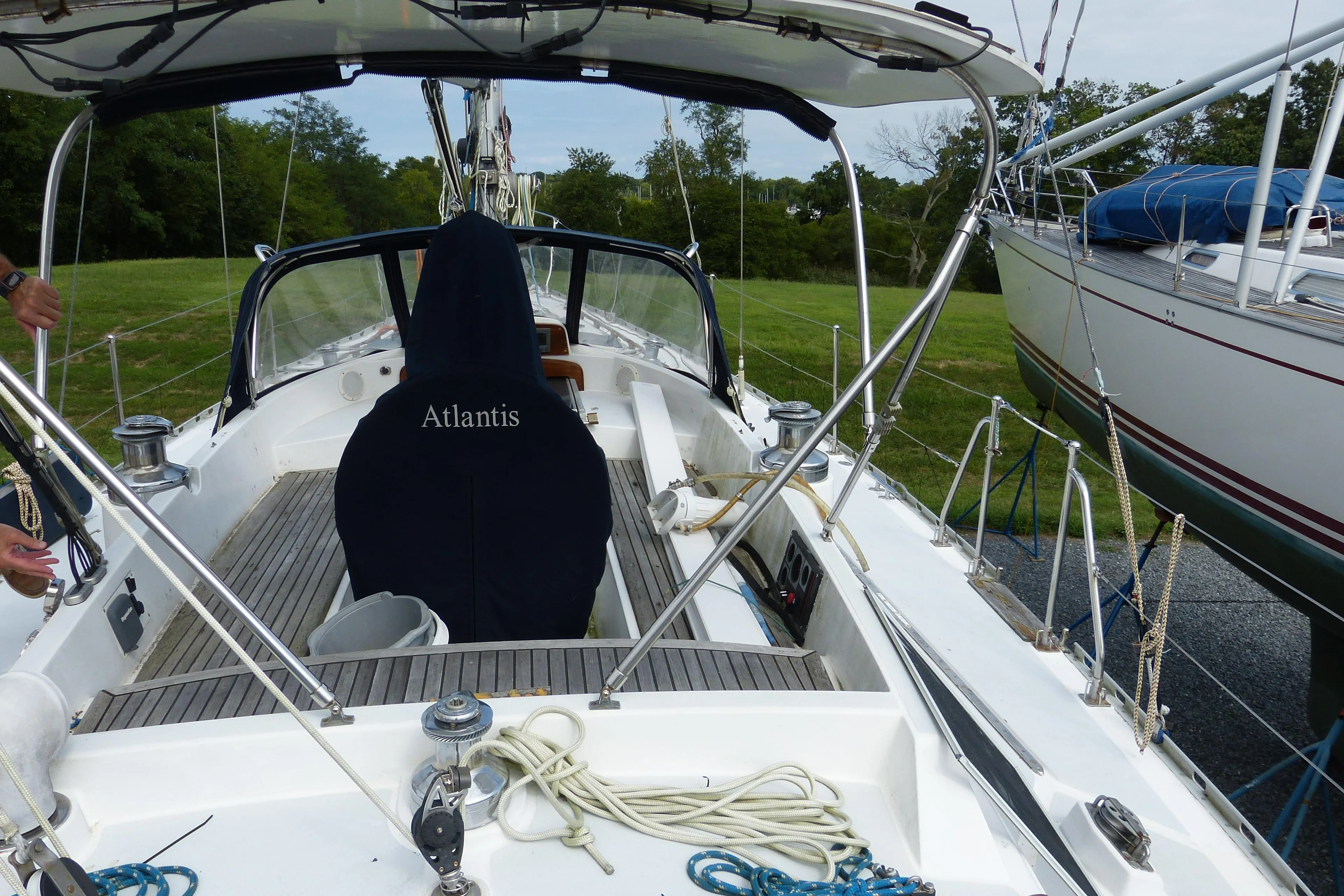 Sailboat cockpit of 1990 Hylas 44, featuring ropes and covered seating.