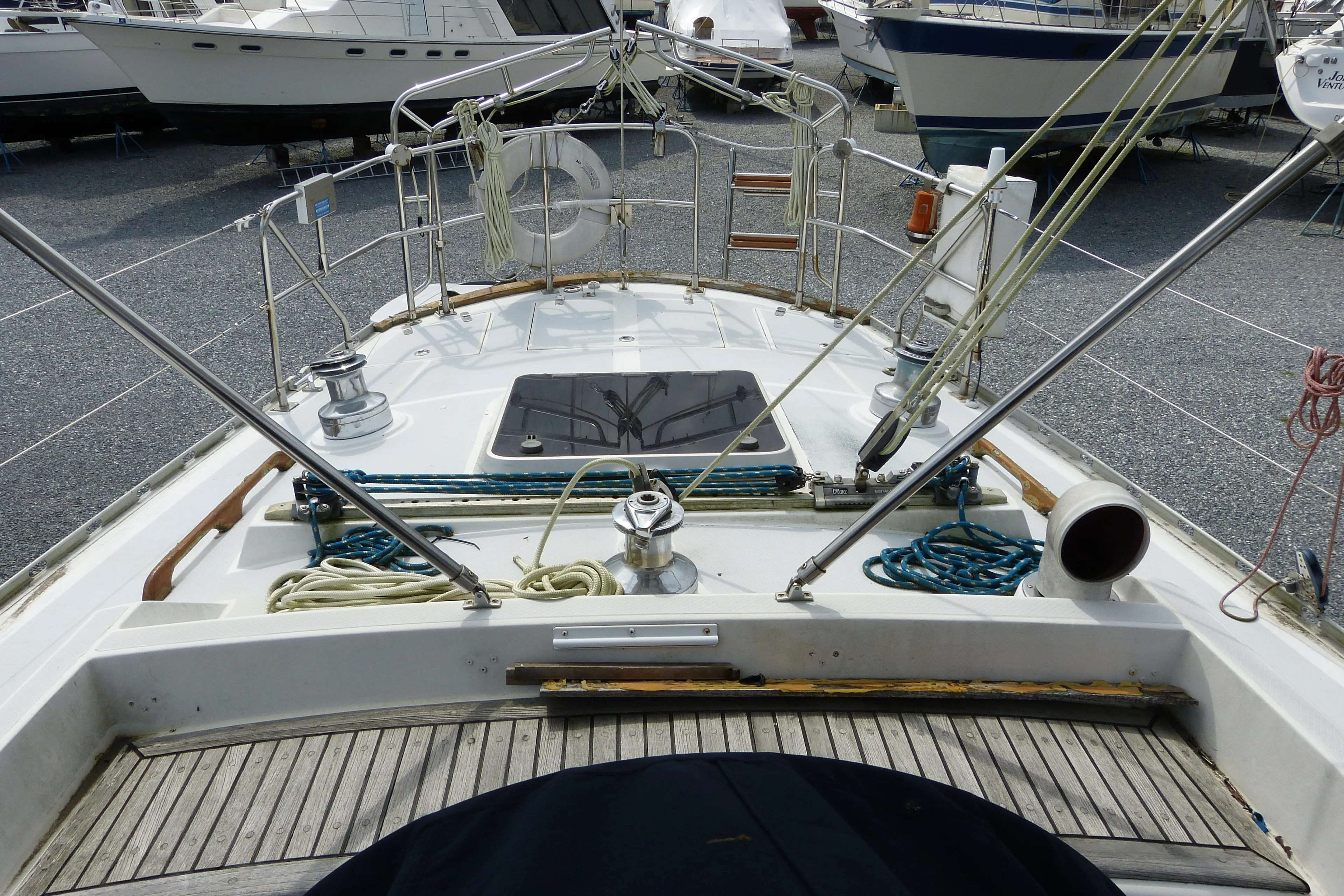 Hylas 44 sailboat deck view, showcasing rigging and equipment, docked among other boats.
