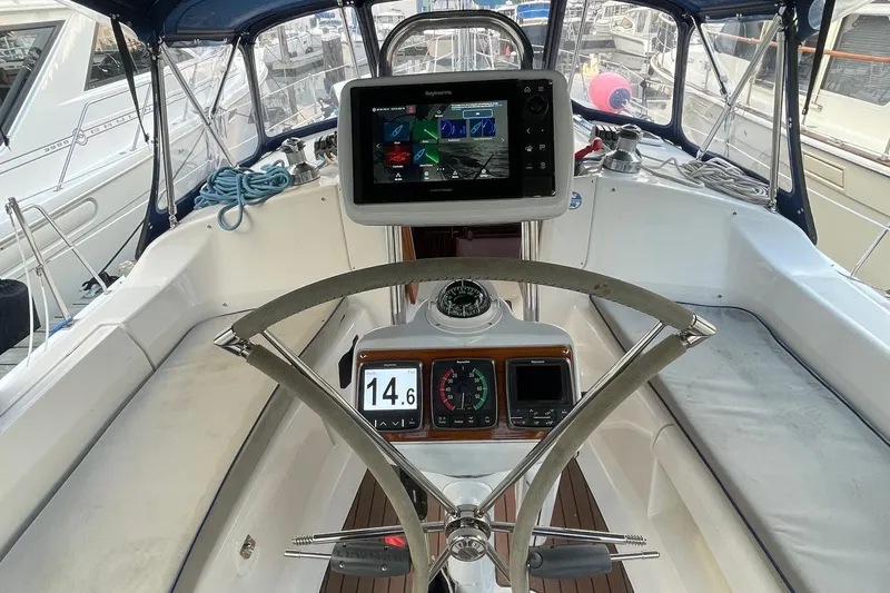  Yacht Photos Pics Cockpit of 2005 Hunter 38 sailboat with navigation equipment and steering wheel.