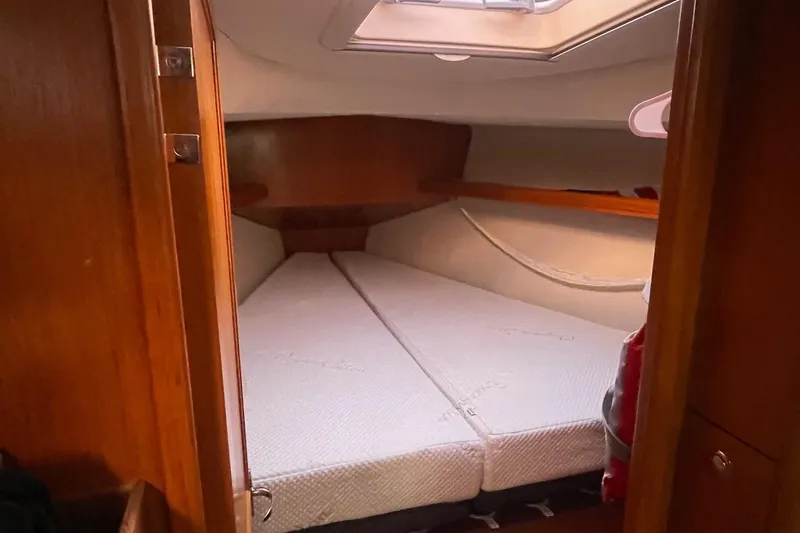  Yacht Photos Pics Cozy cabin interior of 2005 Hunter 38 sailboat with comfortable bedding.