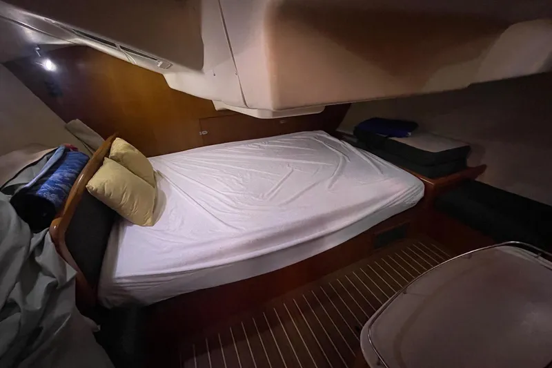  Yacht Photos Pics Cozy cabin interior of 2005 Hunter 38 sailboat with neatly made bed.