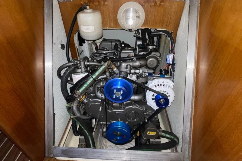  Yacht Photos Pics Engine compartment of a 2005 Hunter 38 sailboat, featuring visible belts and hoses.