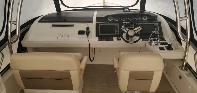 Never Again Yacht Photos Pics 2012 Sea Ray 450 Sedan Bridge helm with dual seats and modern navigation controls.