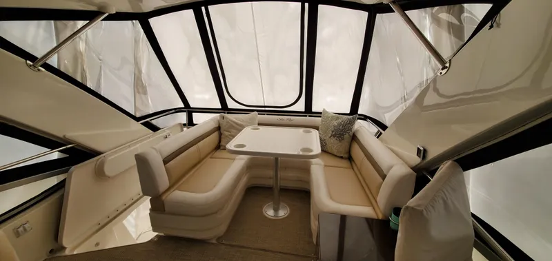 Never Again Yacht Photos Pics Interior of 2012 Sea Ray 450 Sedan Bridge with spacious seating and table.