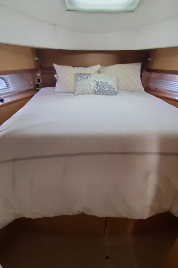 Never Again Yacht Photos Pics 2012 Sea Ray 450 Sedan Bridge cabin with cozy bed and pillows.