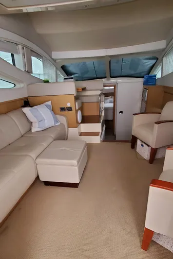 Never Again Yacht Photos Pics Interior of 2012 Sea Ray 450 Sedan Bridge yacht with beige seating and modern design.