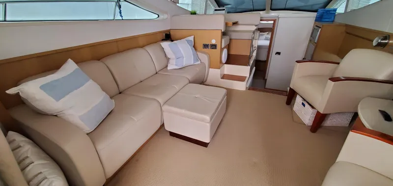Never Again Yacht Photos Pics Luxurious interior of 2012 Sea Ray 450 Sedan Bridge yacht with beige seating.