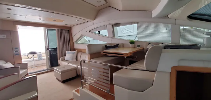 Never Again Yacht Photos Pics Luxurious interior of 2012 Sea Ray 450 Sedan Bridge yacht with elegant seating and dining area.