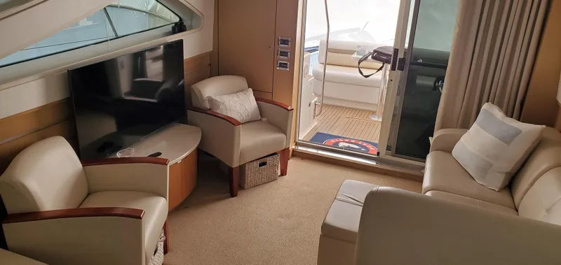 Never Again Yacht Photos Pics Luxurious interior of 2012 Sea Ray 450 Sedan Bridge yacht with comfortable seating and TV.