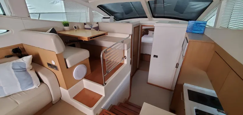 Never Again Yacht Photos Pics Interior of 2012 Sea Ray 450 Sedan Bridge yacht with modern seating and dining area.