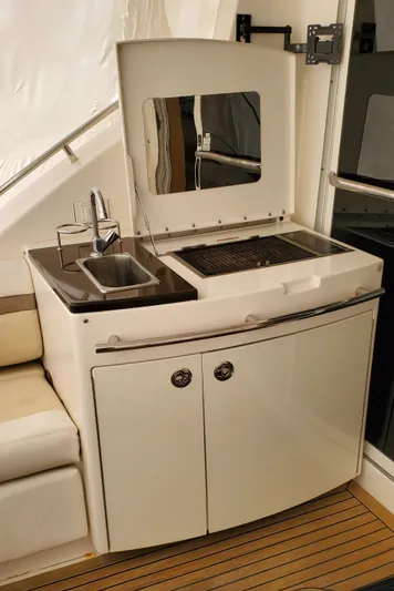 Never Again Yacht Photos Pics 2012 Sea Ray 450 Sedan Bridge yacht kitchenette with sink and grill.