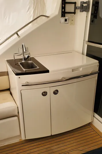 Never Again Yacht Photos Pics Compact kitchenette on 2012 Sea Ray 450 Sedan Bridge yacht with sink and storage.