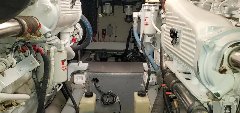 Never Again Yacht Photos Pics Engine room of a 2012 Sea Ray 450 Sedan Bridge yacht, showcasing mechanical components.