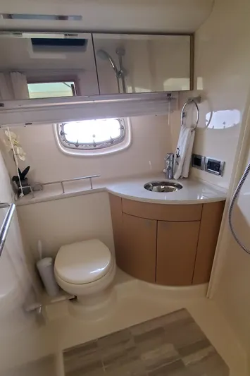 Never Again Yacht Photos Pics 2012 Sea Ray 450 Sedan Bridge bathroom with modern fixtures and compact design.