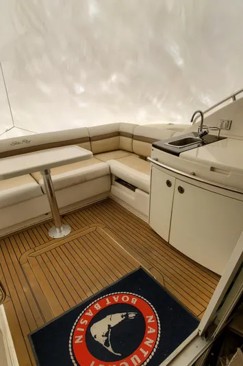 Never Again Yacht Photos Pics Luxurious 2012 Sea Ray 450 Sedan Bridge yacht interior with seating and kitchenette.