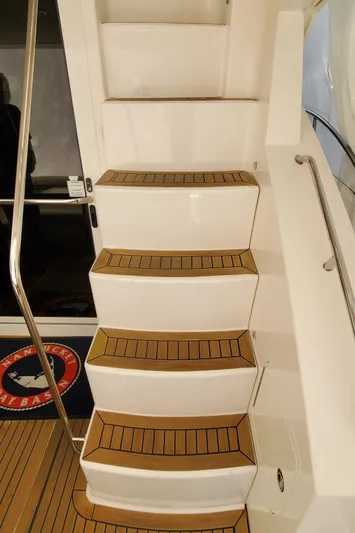 Never Again Yacht Photos Pics Staircase on 2012 Sea Ray 450 Sedan Bridge yacht with teak steps and stainless steel handrail.