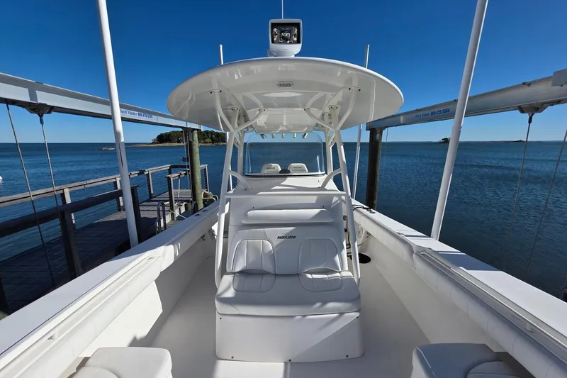  Yacht Photos Pics 2014 Regulator 34 boat docked by the ocean under clear blue skies.