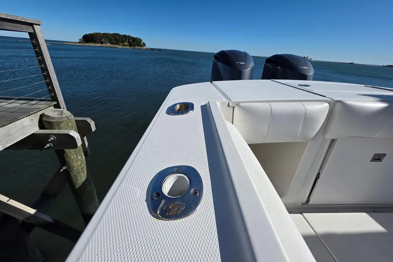  Yacht Photos Pics 2014 Regulator 34 boat docked by serene waters, featuring dual engines and sleek design.