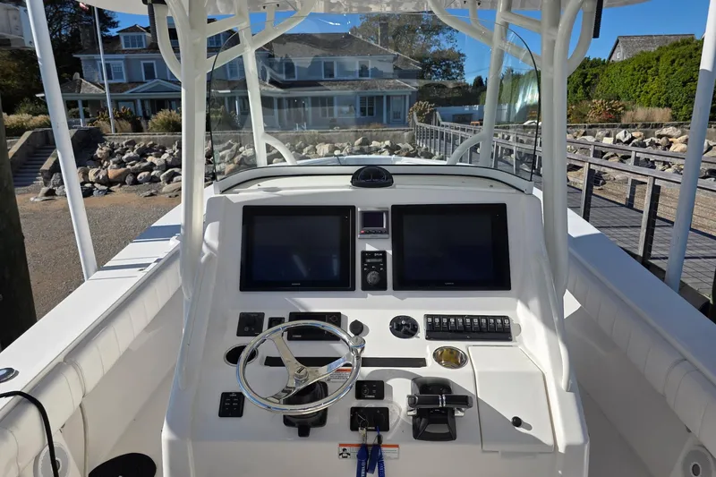  Yacht Photos Pics 2014 Regulator 34 boat cockpit with dual screens and steering wheel.