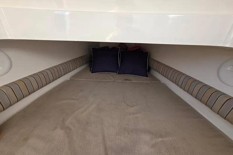  Yacht Photos Pics 2014 Regulator 34 boat cabin interior with striped cushions and pillows.