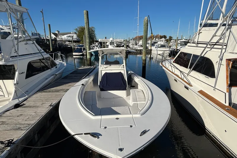  Yacht Photos Pics 2014 Regulator 34 boat docked at a marina, surrounded by other vessels.