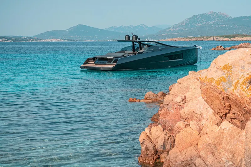 Maori 64 Yacht Photos Pics Luxury Maori 64 yacht from 2026 in turquoise waters near rocky coast.