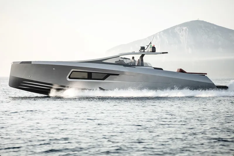 Maori 64 Yacht Photos Pics Maori 64 Yacht 2026 cruising on the sea with mountain backdrop.