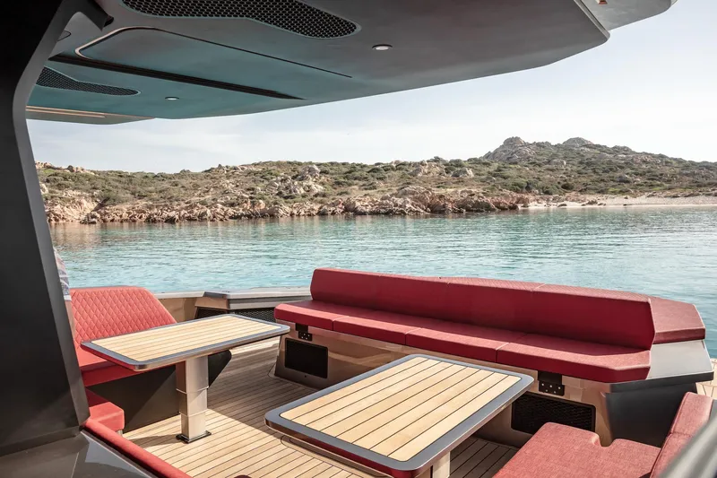 Maori 64 Yacht Photos Pics Luxurious Maori 64 boat with red interior, coastal view.