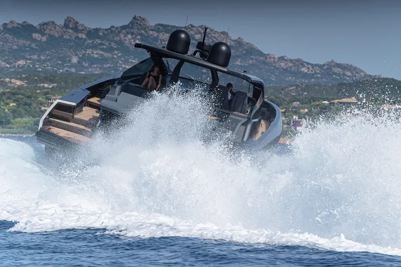 Maori 64 Yacht Photos Pics Maori 64 Yacht 2026 cruising through waves near rocky coastline.