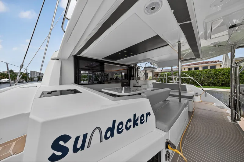 Sundecker Yacht Photos Pics Modern 2021 Leopard 45 catamaran with spacious deck and sleek design, docked at marina.
