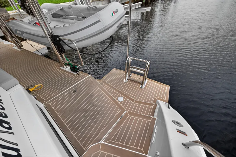 Sundecker Yacht Photos Pics Leopard 45 yacht deck with tender, 2021 model, docked by water.