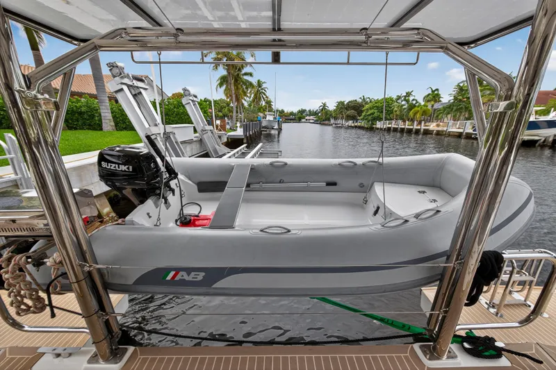 Sundecker Yacht Photos Pics Inflatable boat on Leopard 45 yacht, 2021 model, docked by a scenic canal.