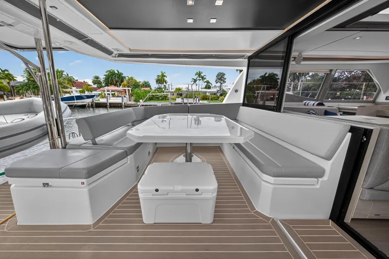 Sundecker Yacht Photos Pics Luxurious 2021 Leopard 45 yacht with elegant outdoor seating and dining area.