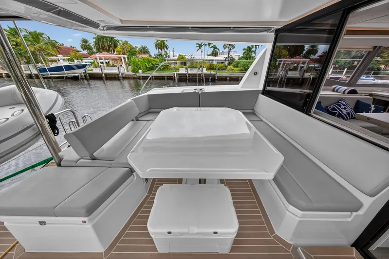 Sundecker Yacht Photos Pics Luxurious 2021 Leopard 45 yacht interior with sleek seating and table, dockside view.