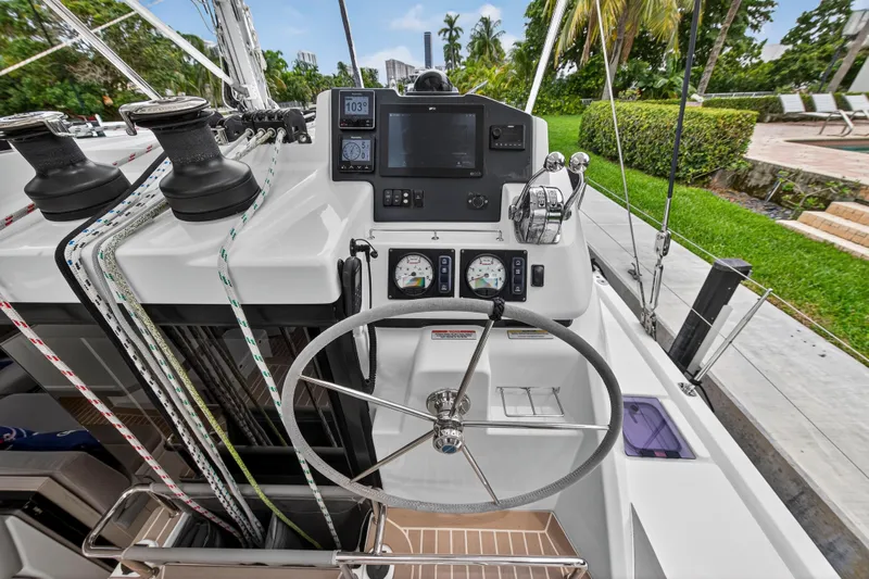 Sundecker Yacht Photos Pics Helm of 2021 Leopard 45 catamaran with navigation instruments and steering wheel.