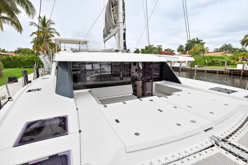 Sundecker Yacht Photos Pics 2021 Leopard 45 catamaran docked, showcasing spacious deck and modern design.