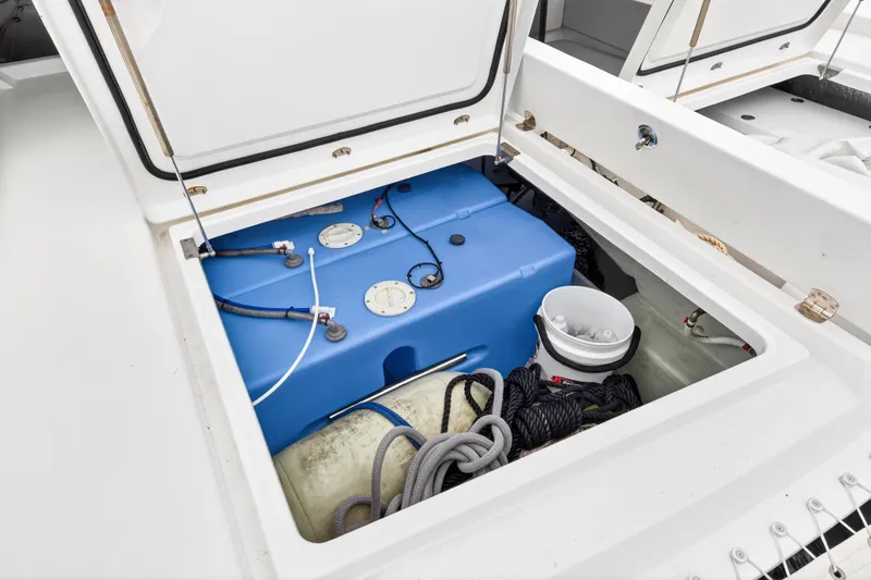 Sundecker Yacht Photos Pics Storage compartment of 2021 Leopard 45 yacht with blue tank and ropes.