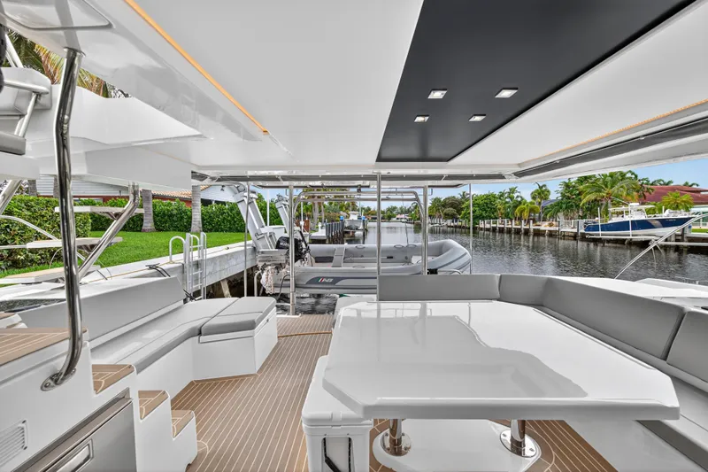 Sundecker Yacht Photos Pics Luxurious 2021 Leopard 45 yacht interior with sleek seating and modern design by the water.