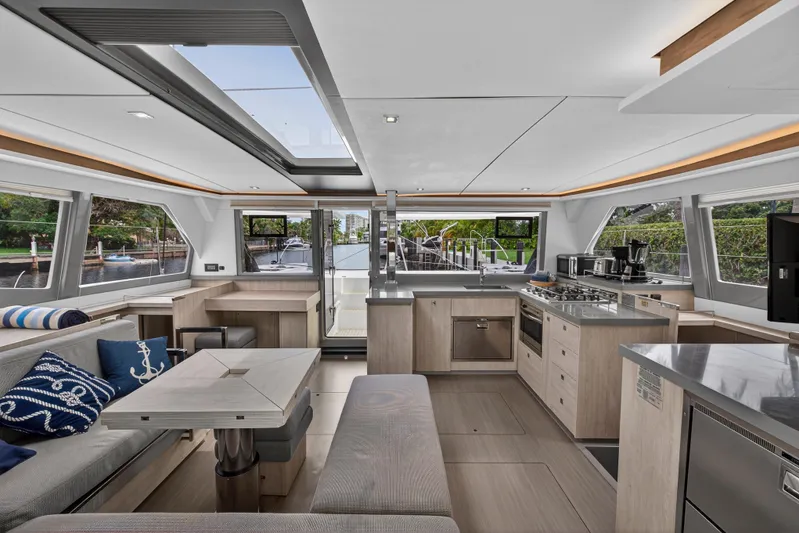 Sundecker Yacht Photos Pics Luxurious interior of 2021 Leopard 45 catamaran with modern kitchen and seating area.