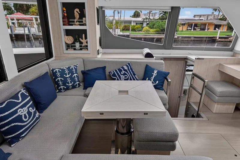 Sundecker Yacht Photos Pics Luxurious interior of 2021 Leopard 45 yacht with nautical-themed cushions and modern decor.