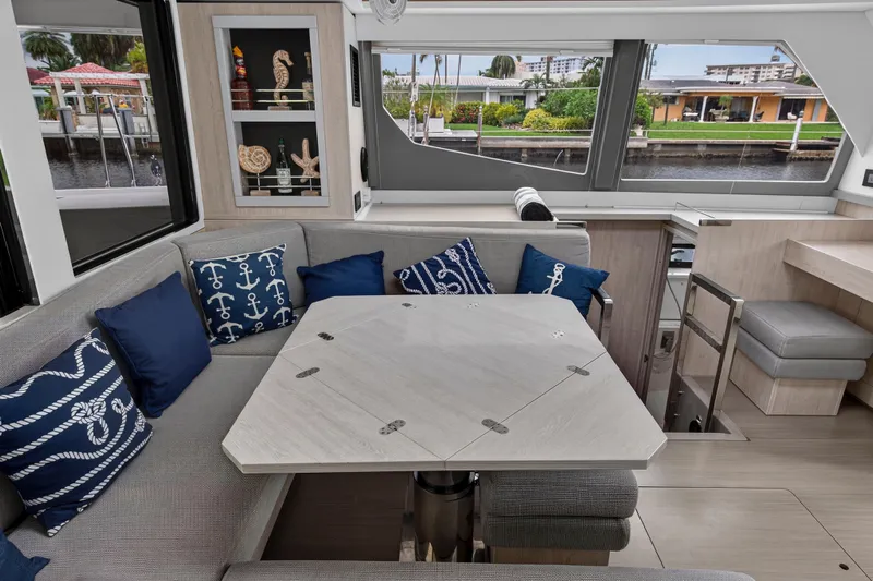 Sundecker Yacht Photos Pics Interior of 2021 Leopard 45 yacht with stylish seating and nautical-themed cushions.