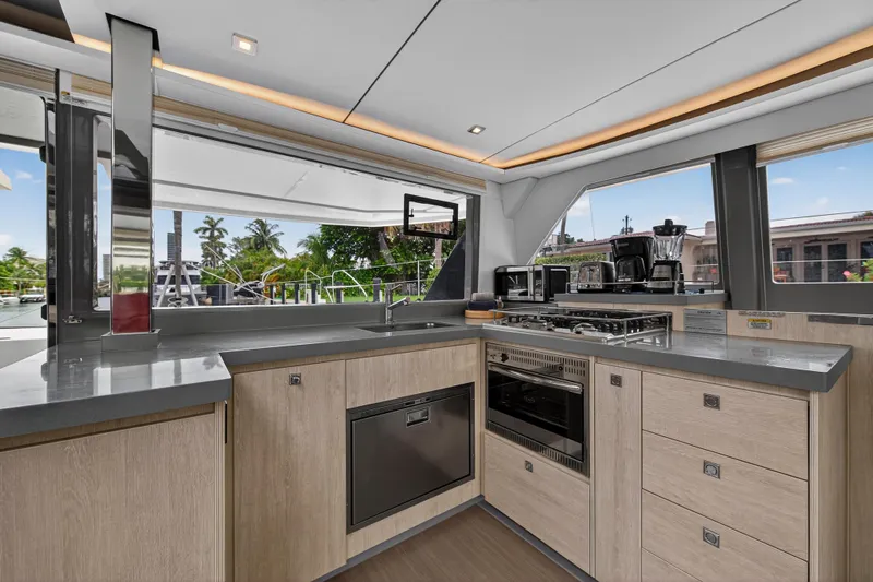 Sundecker Yacht Photos Pics Modern kitchen interior on 2021 Leopard 45 yacht, featuring sleek countertops and appliances.